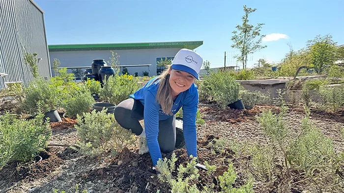 1PointFive Volunteer planting in the butterfly garden at West Texas Food Bank